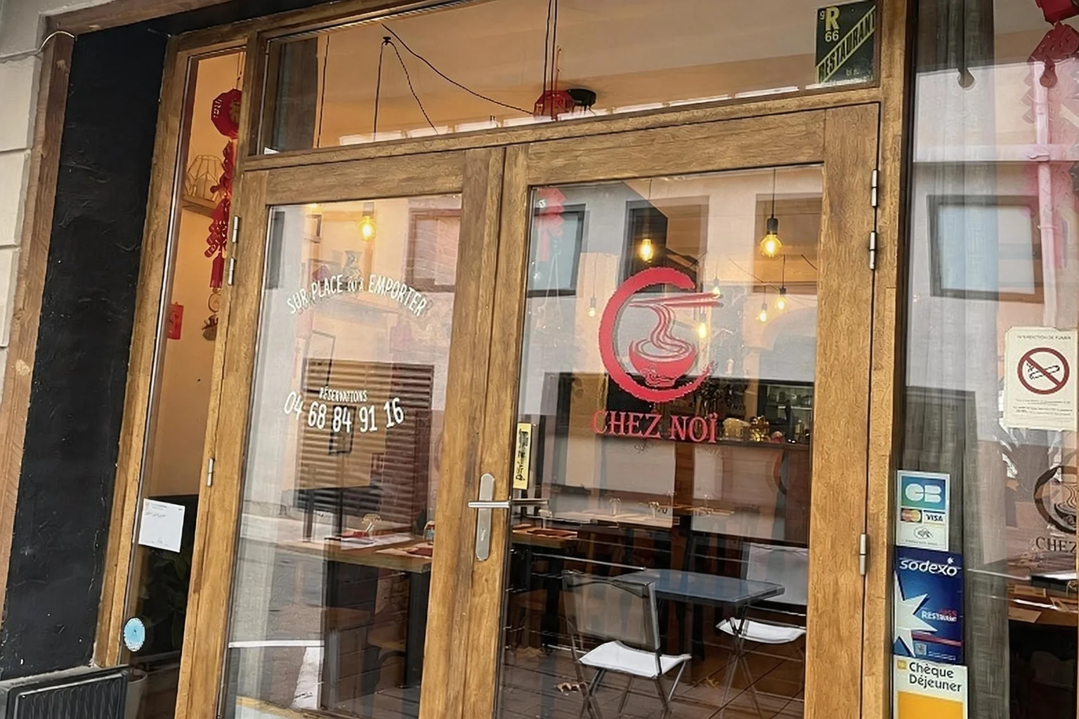 Wooden shopfront, glass door with the CHEZ NOÏ logo